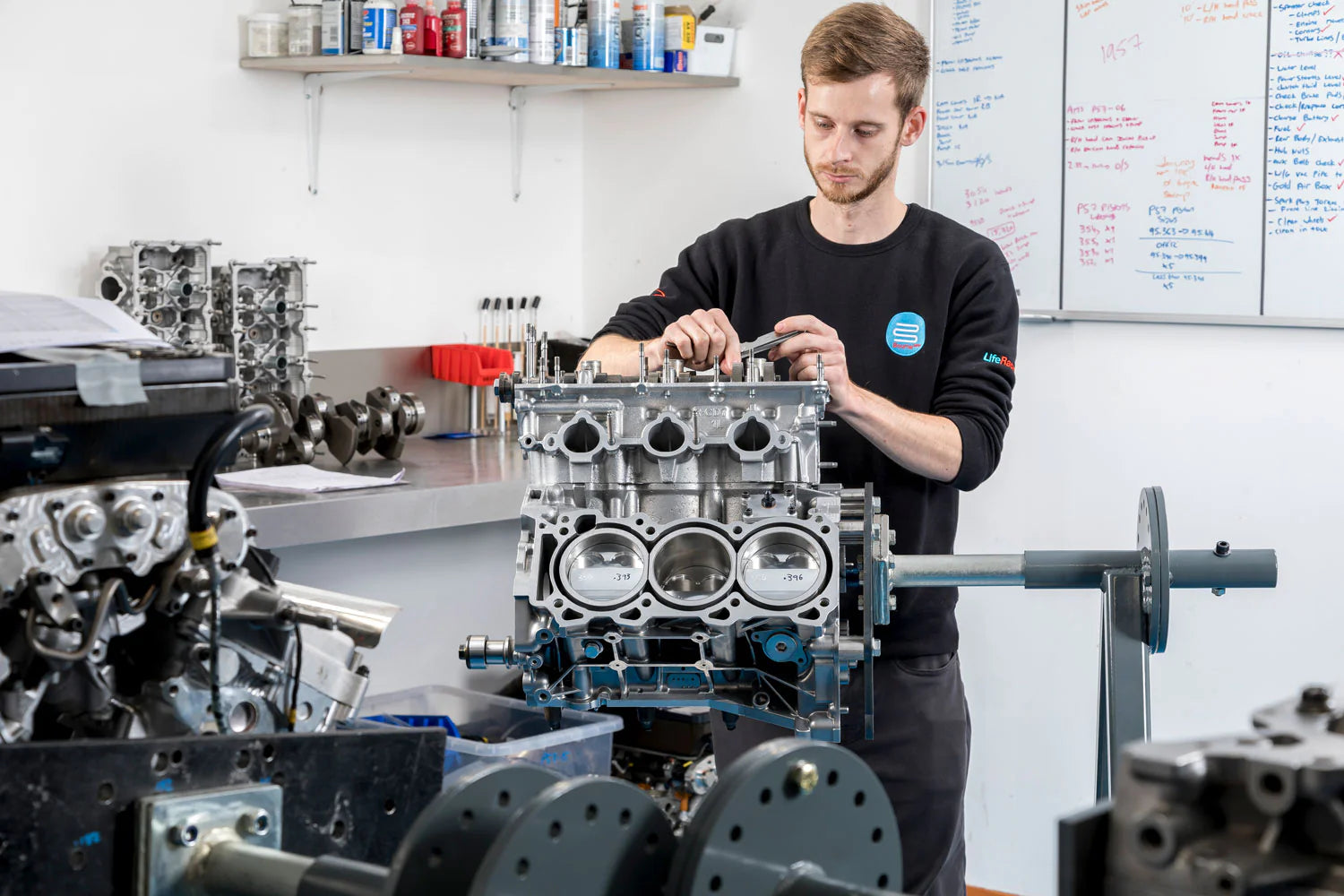 Bourne engineer working on an engine block in a workshop setting