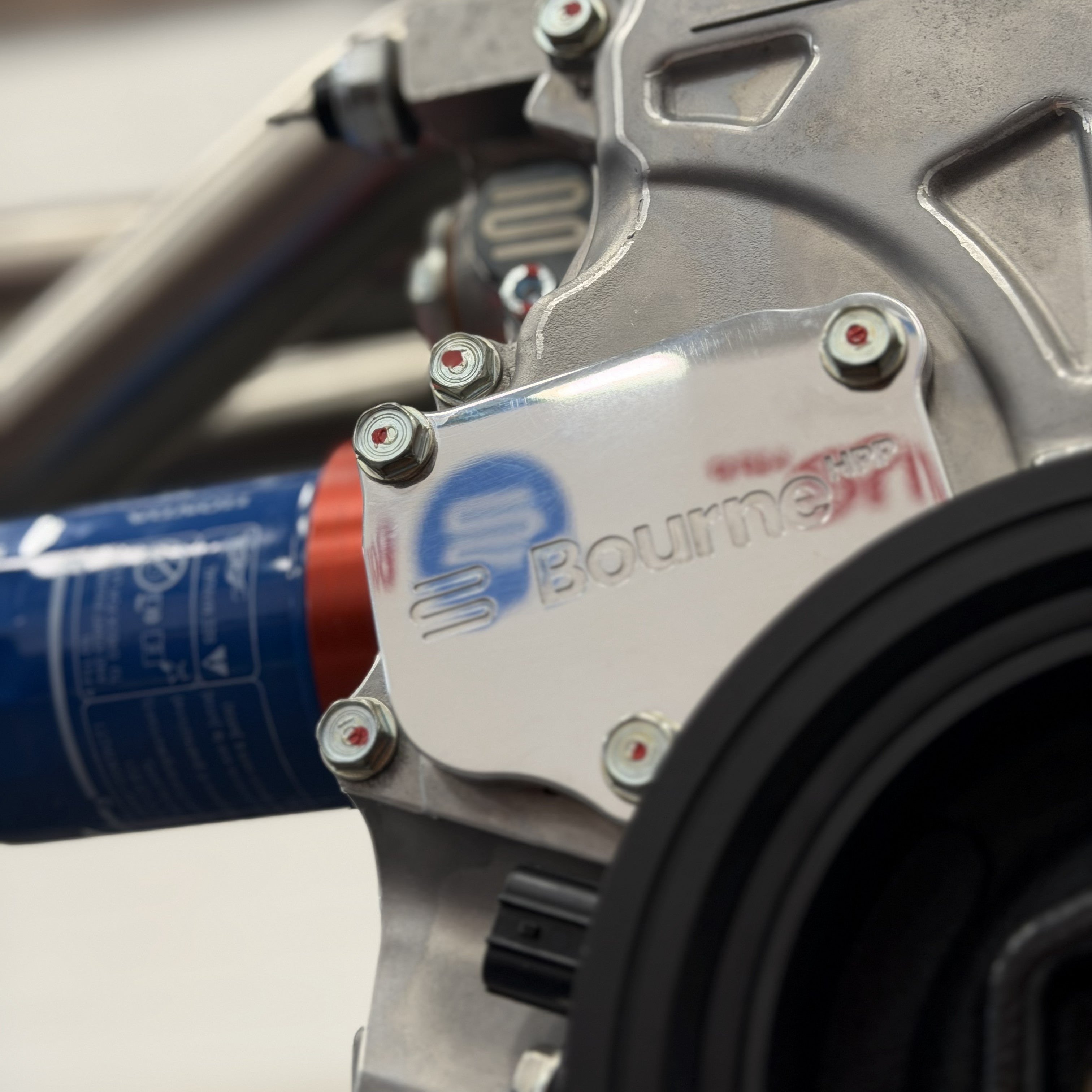 Close-up of a Bourne HPP billet timing chain tensioner cover on the side of Bourne's K20R engine spec.