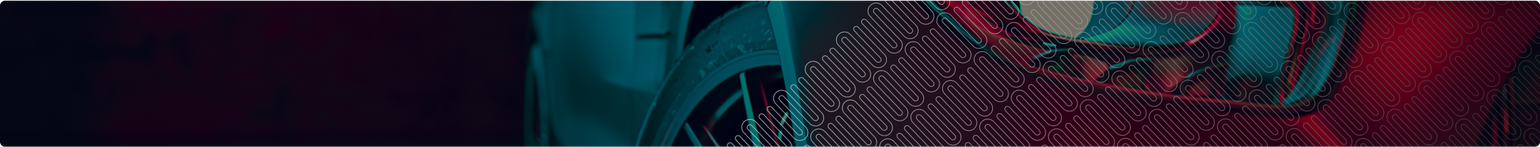 Close-up of a race car bumper with a brand logo on a dark background