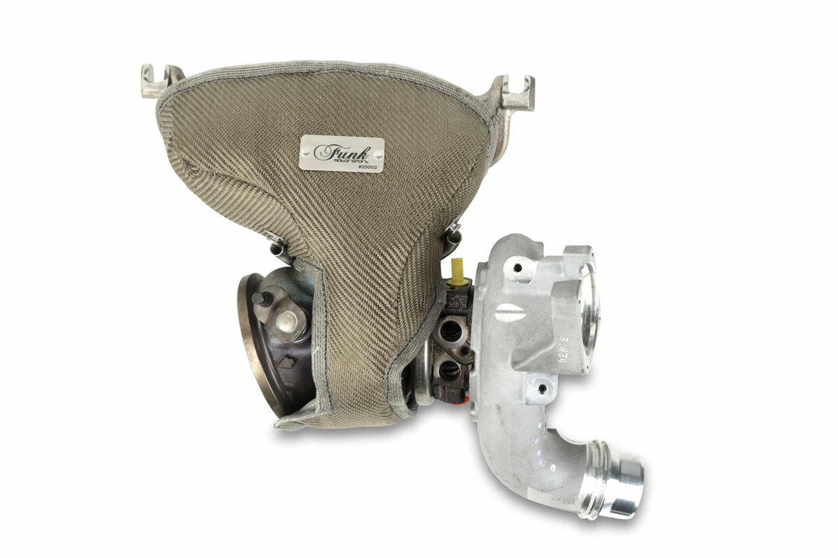 BMW G82 M4 CS turbo blanket by Funk Motorsport, showcasing black heat-resistant material with branding and detailed stitching.