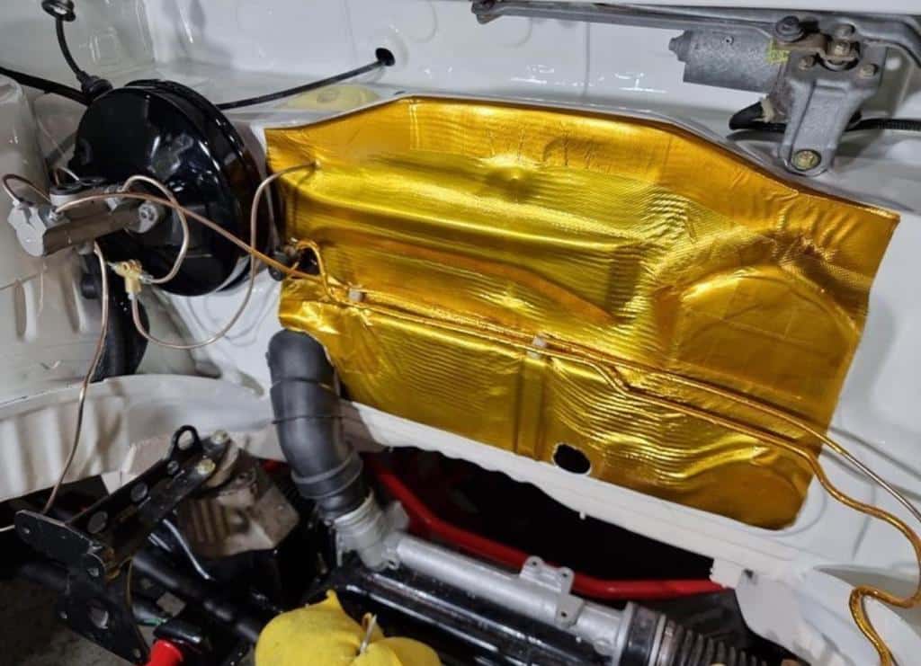 Funk Motorsport adhesive reflective gold heat blanket used as intake protection, showing a gold heat shield with adhesive backing.