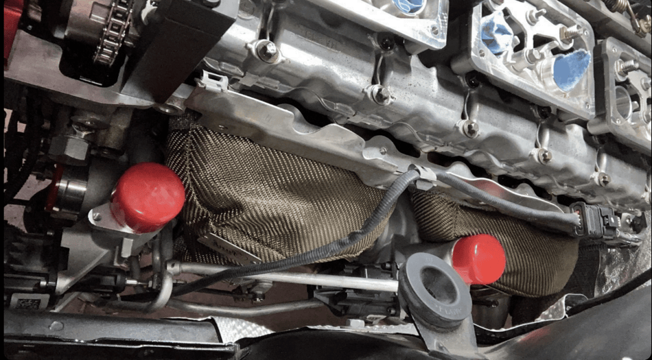 Funk Motorsport BMW F82 M4 turbo blanket draped over engine bay, designed for BMW 4 Series turbocharged engines, black fabric.