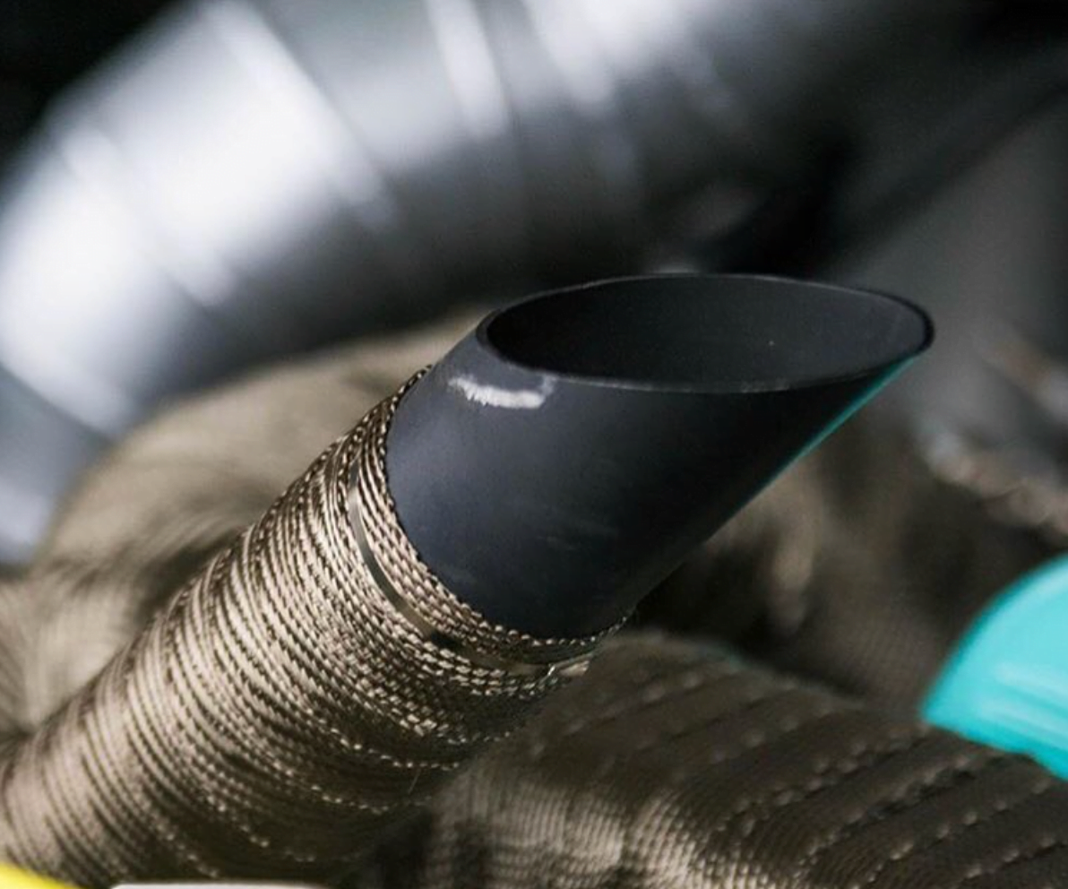 Funk Motorsport titanium exhaust wrap for heat protection on automotive exhaust systems, shown in a close-up image.