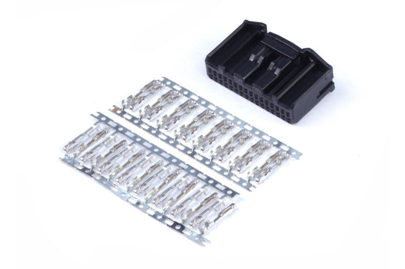 Haltech 32-pin TYCO plug and pin accessories shown, used for automotive wiring and electrical connections.