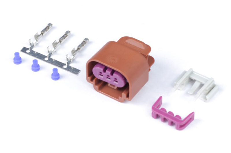 Haltech plug and pins for flex fuel composition sensor, showing metal connectors and wiring for sensor installation.