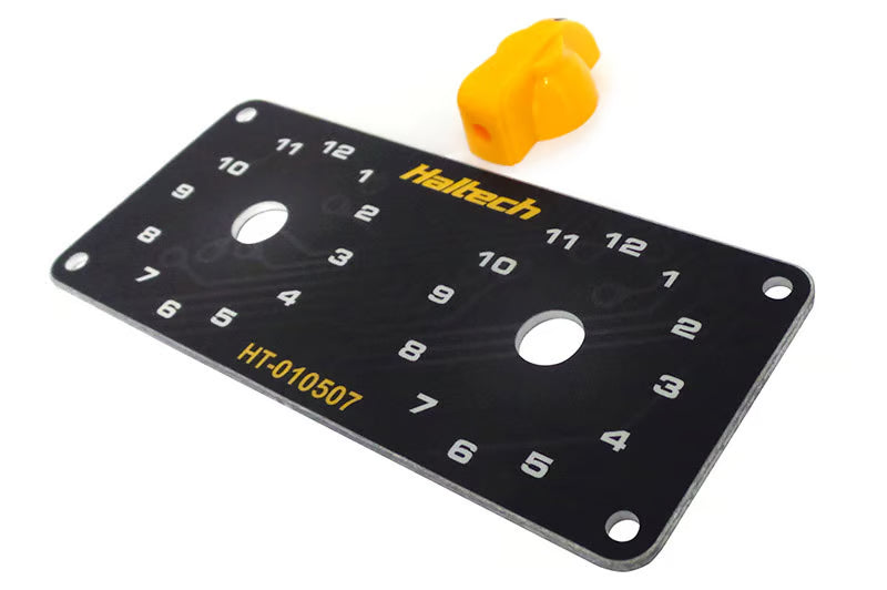 Haltech dual switch panel with yellow knob, automotive accessories, featuring toggle switches for vehicle control.