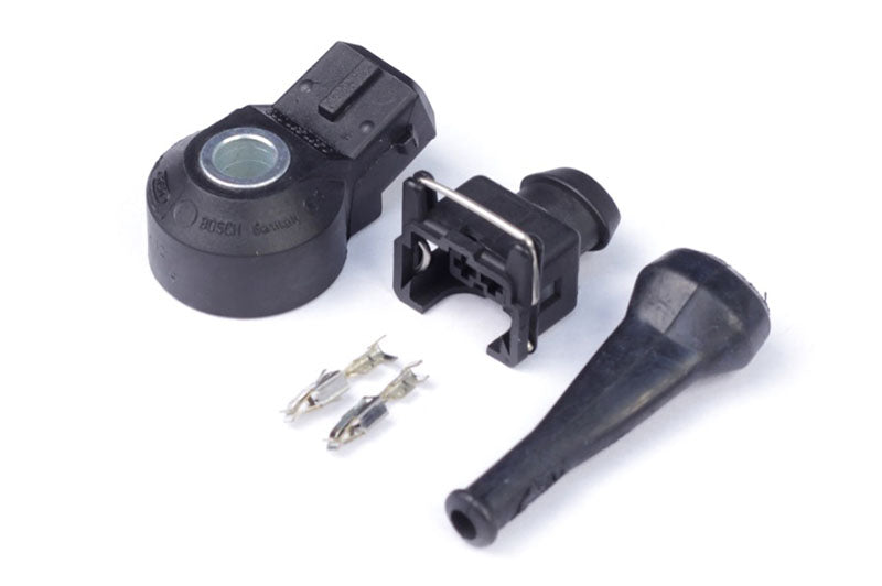 Haltech Bosch knock sensor showing the round sensor element and wiring for engine vibration detection.