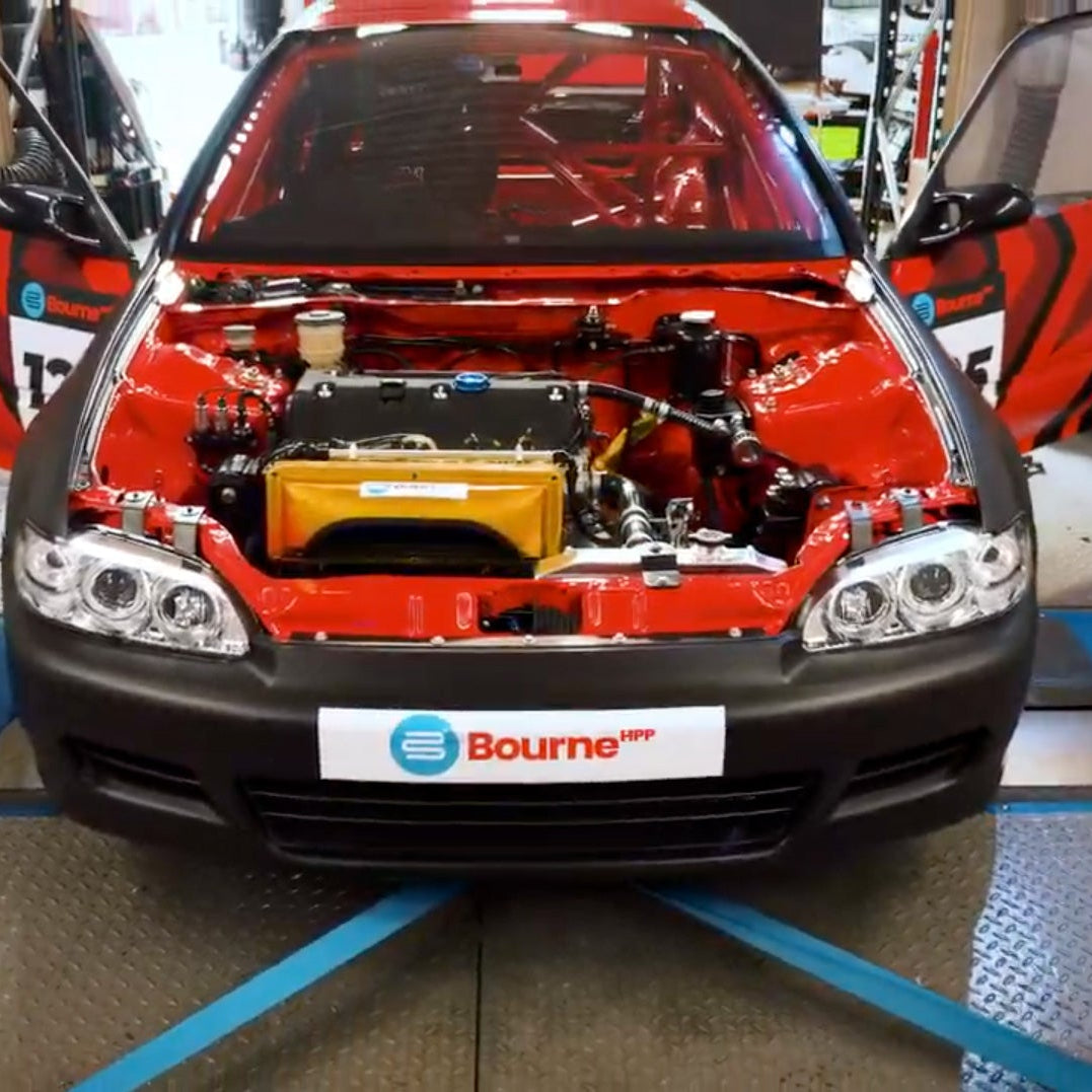 Red civic EG with its hood open on a rolling road, displaying the engine, with 'Bourne' branding.